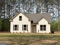 Charming single-Gathering home showcasing a well-manicured lawn and inviting facade at 1547 South Bethany Rd, Locust Grove, GA 30248