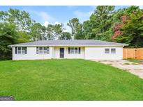 Charming single-story home with a well-maintained lawn and mature trees at 429 Landers Sw Dr, Mableton, GA 30126