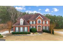 Brick house with a two-car garage and a large front yard at 120 Imperial Way, Fayetteville, GA 30214