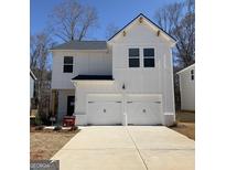 Two-story modern farmhouse-style home featuring a two-car garage and a clean white facade at 188 Weldon Rd # 23, Mcdonough, GA 30253