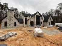 Elegant two-story home with stone and white brick exterior, under construction at 1315 Sandy Creek Rd, Tyrone, GA 30290