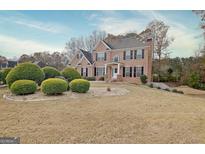 Stately brick home featuring a well-manicured lawn and a classic architectural design at 355 Woodbyne Dr, Fayetteville, GA 30214