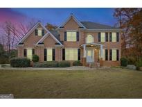 Beautiful brick two-story home with black shutters and a well-manicured lawn on a spacious lot at 355 Woodbyne Dr, Fayetteville, GA 30214