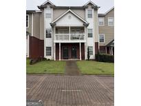 Traditional townhouse showcasing a classic facade, charming balcony, and well-manicured lawn at 251 Ralph David Abernathy Sw Blvd, Atlanta, GA 30312