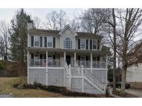 Charming two-story home featuring a spacious front porch and classic architectural details at 3722 Lockerbie Ln, Powder Springs, GA 30127