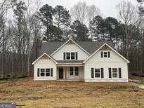 New two-story home boasts light siding, dark shutters, and a covered front porch at 240 Jay Trl, Fayetteville, GA 30215