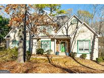 Two-story house with green accents and a stone facade at 232 Terrane Rdg, Peachtree City, GA 30269