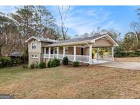 Charming home featuring a covered carport and inviting front porch at 3435 Misty Valley Rd, Decatur, GA 30032