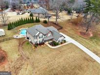 Aerial view of two-story house with pool and landscaped yard at 209 Enfield Ln, Mcdonough, GA 30252