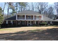 Brick home with balcony and landscaped yard at 5651 Bahia Mar Cir, Smoke Rise, GA 30087