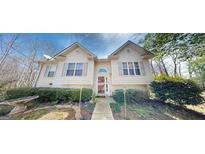 Charming home featuring symmetrical design, neutral siding, and well-maintained landscaping at 15 Huntington Dr, Grantville, GA 30220
