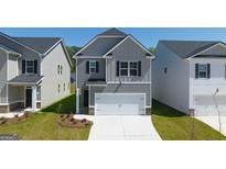 Two-story house with gray siding, and a two-car garage at 12116 Conrad Cir # 114, Hampton, GA 30228