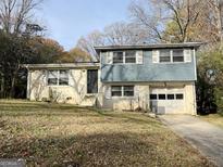 Charming two-story home with brick and blue siding on a tree filled lot at 422 Windsor Dr, Forest Park, GA 30297