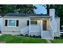 Charming ranch home with a newly renovated exterior, featuring a covered porch and landscaping at 1222 Bronx Nw St, Atlanta, GA 30314