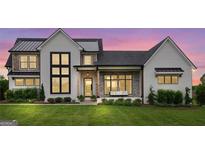 Stunning two-story farmhouse with white exterior, metal roof, and stone accents at 0 Matteo Way # 34, Fayetteville, GA 30215