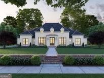 Elegant two-story home with a manicured lawn and brick walkway at 0 Matteo Way # 12, Fayetteville, GA 30215