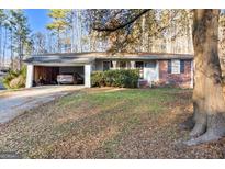 Brick ranch home with attached carport and yard at 2702 Beecher Dr, Austell, GA 30106