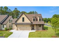 Craftsman style home with a two-car garage and nicely landscaped lawn at 202 Regester Way # 46, Peachtree City, GA 30269