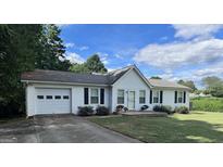 White house with attached garage and landscaped yard at 3772 Saddle Ridge, Snellville, GA 30039