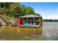 Covered boat dock with seating, perfect for enjoying lake views at 440 Yancey Cir, Covington, GA 30014