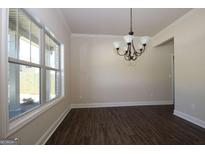 Bright dining room with hardwood floors and a chandelier at 5720 Laney Dr # Ln23, Rex, GA 30273