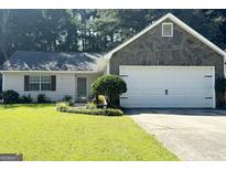 Ranch style home with stone accents and a two-car garage at 7665 Antebellum Ln, Riverdale, GA 30274