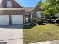 Brick ranch home with two-car garage and landscaped lawn at 4230 Vinca Way, Union City, GA 30291