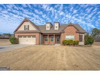 Brick ranch home with 2-car garage and landscaped yard at 417 Creekside Park, Covington, GA 30014