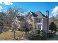 Brick two-story home with landscaped yard and large windows at 3443 Pinemont Dr, Douglasville, GA 30135