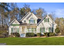 Two-story house with green shutters and a manicured lawn at 180 Rock Hill Dr, Fayetteville, GA 30215