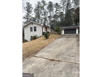 Charming home featuring painted brick, a large driveway, and an attached two car garage at 2358 Columbia Dr, Decatur, GA 30032