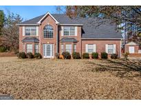Brick two-story house with a large front yard and attached garage at 360 Kaleb C, Mcdonough, GA 30252