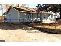 Ranch style home with a long driveway and fenced yard at 6160 Dodson Rd, Union City, GA 30291