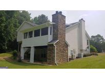 Two-story house with stone accents and a screened porch at 2477 Briar Valley Way, Dacula, GA 30019