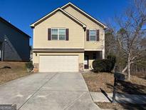 Charming two-story home with a well-maintained lawn and a two-car garage at 606 Grenier Ter, Lawrenceville, GA 30045