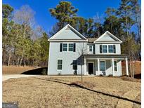 Charming two-story home with light blue siding, black shutters, and a well-manicured front yard at 2791 Riverchess Ct # 147, Atlanta, GA 30331