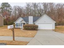 Ranch style home with attached garage and well-manicured landscaping at 190 Wynfield Dr, Covington, GA 30016