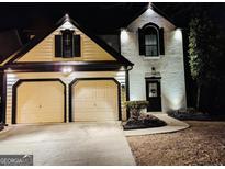 Two-story house with two-car garage, illuminated at night at 2587 Alvecot Se Cir, Atlanta, GA 30339