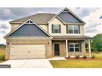 Two-story house with a neutral color scheme and a three-car garage at 328 Trulove Lane Lot 32 # 32, Locust Grove, GA 30248