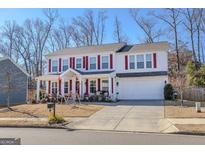 Two-story house with red shutters, front porch, and attached garage at 236 Augusta Walk, Canton, GA 30114