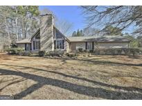 Brick ranch house with a large yard and mature trees at 2984 Walt Stephens Rd, Jonesboro, GA 30236