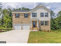 Two-story brick home with a two car garage and landscaped lawn at 760 Great Oak Pl # 22, Villa Rica, GA 30180