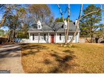 White house exterior with landscaping and long driveway at 103 Pine Pt, Peachtree City, GA 30269