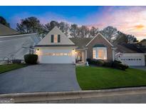 Brick ranch home with attached garage and landscaped lawn at 1048 Pinehurst Dr, Peachtree City, GA 30269