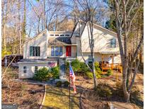 Two-story house with wood siding, multiple windows, and a deck at 8806 Clear Creek Ct, Douglasville, GA 30135