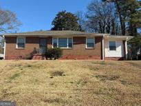 Brick ranch house with a spacious yard at 1964 E Lakeside Dr, Decatur, GA 30032