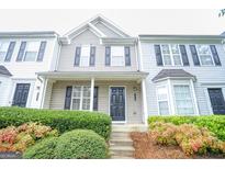 Two-story townhome with gray and white siding, black shutters, and landscaping at 6527 Arbor Gate Sw Dr # Bldg 12, Mableton, GA 30126