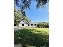 Charming ranch house with white siding, landscaping, and a spacious yard at 2735 Sandy Creek Cir, Loganville, GA 30052