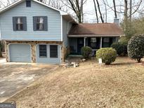 Ranch style home with attached garage and landscaped yard at 5303 Kemper Pl, Stone Mountain, GA 30088