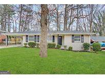 Brick ranch home with a large front yard and mature trees at 2304 Springdale Sw Cir, Atlanta, GA 30315